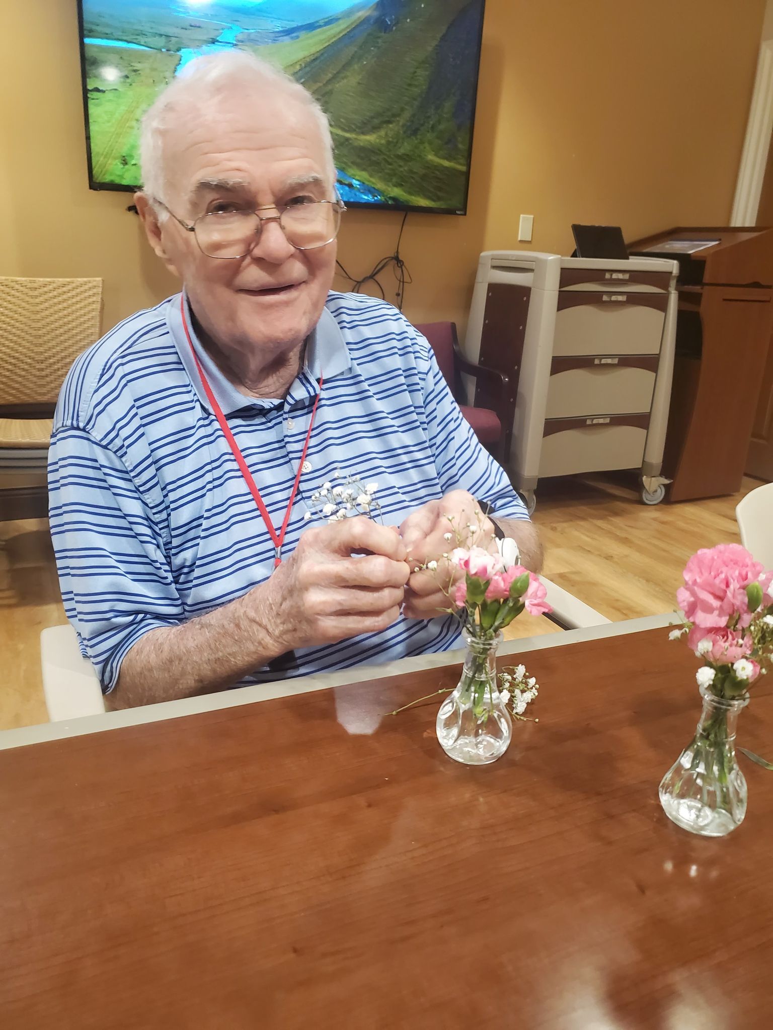 memory care activity - arranging flowers - Bob smiling arranging flowers
