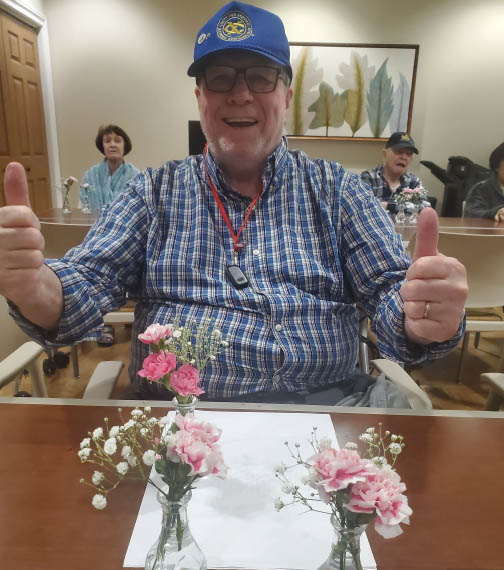 memory care activity - flower arranging - Tom smiling big 