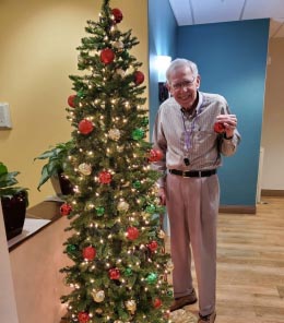 memory care resident posing with tree